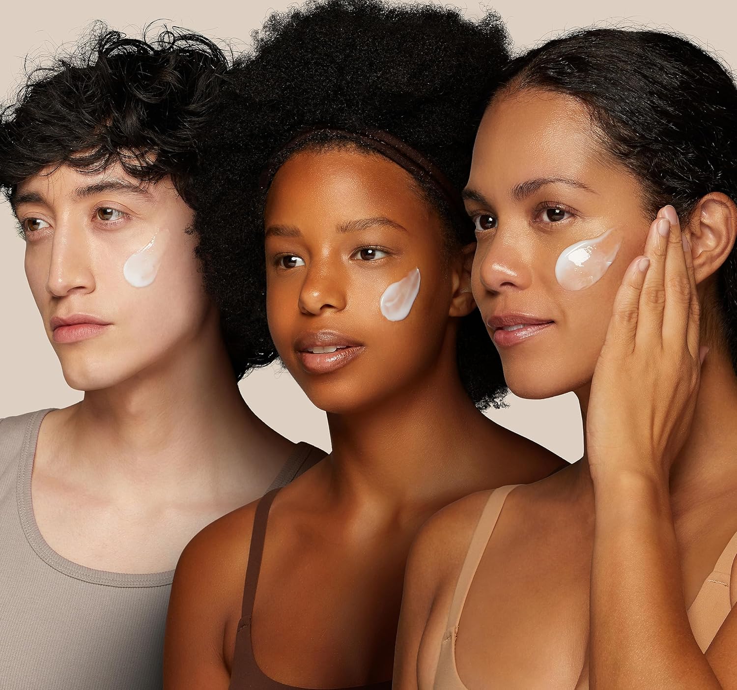 Three people with cosmetic products on their faces against a beige background